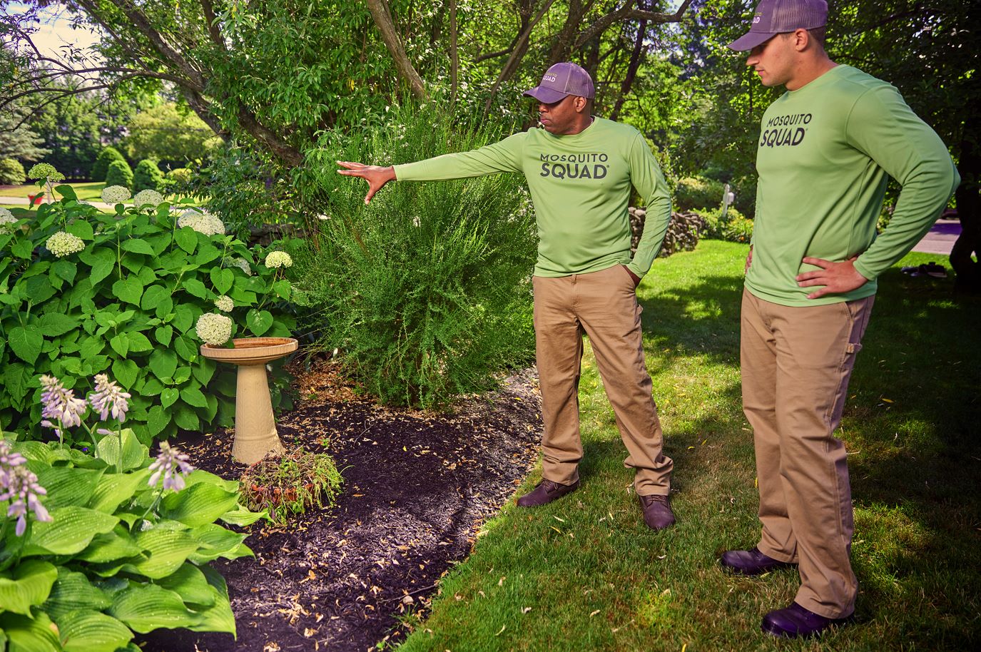 Mosquito Squad franchise owner standing in front yard of customer home