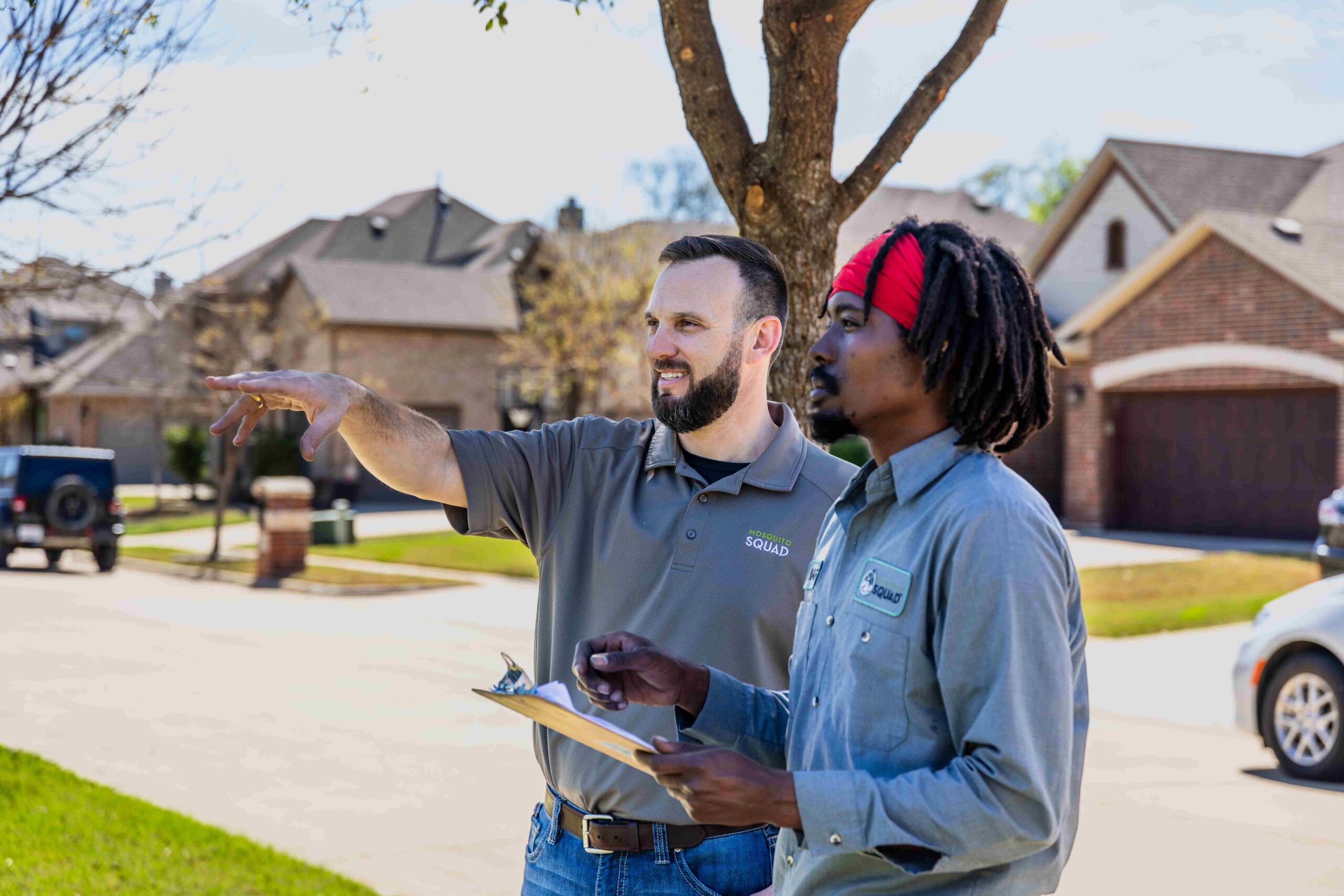 Mosquito Squad technician and franchise owner assessing customer's yard