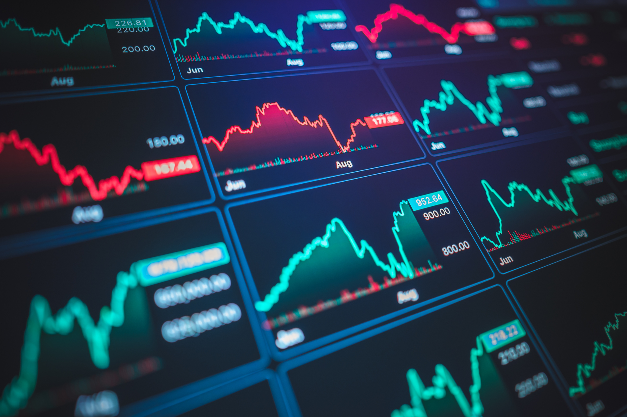 Stock market charts on a screen.